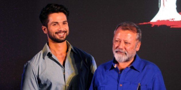 Indian Bollywood actors Shahid Kapoor (L) and Pankaj Kapur pose for a photograph during a promotional event for the forthcoming film 'Haider, Omkara and Maqbool ' directed by Vishal Bhardwaj (R) in Mumbai on late September 30, 2014. AFP PHOTO/STR (Photo credit should read STRDEL/AFP/Getty Images)
