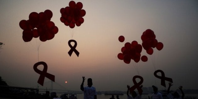 Indian social activists and children release ribbons and balloons during an event to mark World AIDS Day in Kolkata on December 1, 2014. According to the UN AIDS programme, India had the third-largest number of people living with HIV in the world at the end of 2013 and it accounts for more than half of all AIDS-related deaths in the Asia-Pacific region. In 2012, 140,000 people died in India because of AIDS. The Indian government has been providing free antiretroviral drugs for HIV treatment since 2004, but only 50 percent of those eligible for the treatment were getting it in 2012, according to a report by the World Health Organisation. AFP PHOTO/Dibyangshu SARKAR (Photo credit should read DIBYANGSHU SARKAR/AFP/Getty Images)