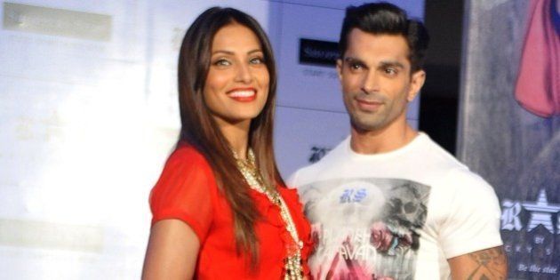Indian Bollywood actress Bipasha Basu (L) poses with actor Karan Singh Grover during the launch of designer fashion brand 'RS by Rocky Star collection' in Mumbai on July 7, 2015. AFP PHOTO/STR (Photo credit should read STRDEL/AFP/Getty Images)
