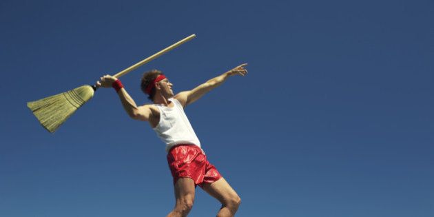 Nerdy man throws broom as javelin in his own special version of a track and field event