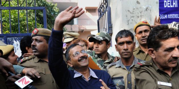 Aam Aadmi Party, or Common Man's Party, leader Arvind Kejriwal waves to residents as he comes out of a polling station after casting his vote in New Delhi, India, Saturday, Feb. 7, 2015. Voters cast ballots in the Indian capital on Saturday in an election that is seen as a litmus test for the popularity of Prime Minister Narendra Modi and his Hindu nationalist party. Opinion polls ahead of the vote to choose New Delhi's 70-member assembly suggest that Modi's Bharatiya Janata Party is either locked in a close contest with the upstart Common Man's Party or will come in second. (AP Photo/Altaf Qadri)