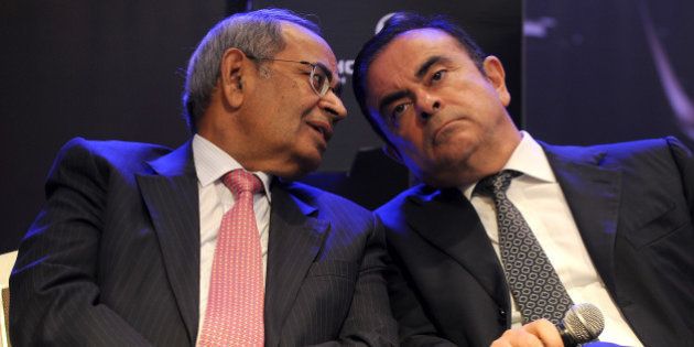 CEO and chairman of Renault-Nissan, Carlos Ghosn (R) and co-chairman of Hinduja Group, G.P. Hinduja share a point during the launch of Hinduja Group's flagship brand, Ashok Leyland's multi-purpose vehicle (MPV) 'STILE', in Chennai on July 16, 2013. 'STILE' was developed as part of the joint venture between Ashok Leyland and Nissan Motor Company. Ashok Leyland and Nissan Motor Company had inked a Master Co-operation Agreement (MCA) in October 2007 for vehicle manufacturing, powertrain manufacturing and technology development. Under the MCA, one of the joint ventures is to manufacture Light Commercial Vehicles (LCVs), in which Ashok Leyland has an equity stake of 51 per cent and Nissan 49 per cent. Stile is the second product offering from this joint venture. AFP PHOTO/Manjunath KIRAN (Photo credit should read Manjunath Kiran/AFP/Getty Images)
