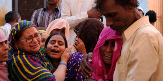 GREATER NOIDA, INDIA - SEPTEMBER 29: Family members of Mohammad Akhlaq (50-year-old man) mourn during his funeral at their village in Bisada on September 29, 2015 in Greater Noida, India. Akhlaq was beaten to death and his son critically injured by a mob over an allegation of storing and consuming beef at home, late night on Monday, in UPs Dadri. Police and PAC were immediately deployed in the village to maintain law and order. Six persons were arrested in connection with the killing of man. (Photo by Burhaan Kinu/Hindustan Times via Getty Images)