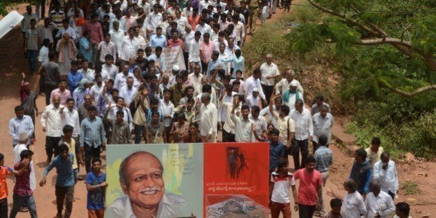 Indian mourners follow the funeral procession for scholar M.M. Kalburgi as he is taken to be buried at Karnataka University in Dharwad on August 31, 2015. Indian scholars on August 31, 2015 condemned the execution-style killing of a leading scholar who had spoken out against idol worship and angered hardline Hindu groups in the run-up to his death. M.M. Kalburgi, an academic and writer from southern Karnataka state, was shot in the forehead after opening the door of his home on August 30 and later died in hospital, police said. AFP PHOTO / STR (Photo credit should read STRDEL/AFP/Getty Images)