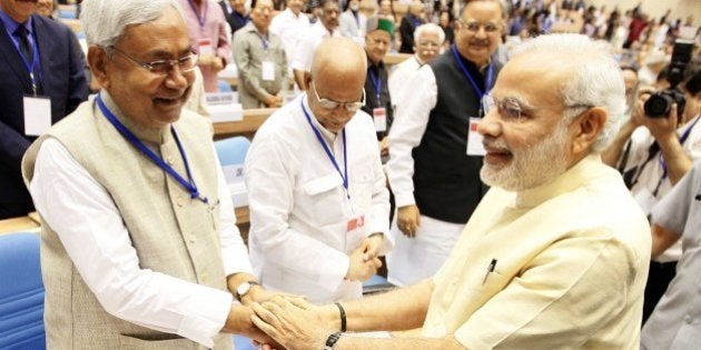 NEW DELHI, INDIA - APRIL 5: Prime Minister Narendra Modi and Chief Minister of Bihar Nitish Kumar during the joint conference of the Chief Ministers and the Chief Justices of High Courts at Vigyan Bhawan, on April 5, 2015 in New Delhi, India. Talking about judicial system, Modi said that what the people in judicial system do is divine and God has sent them to carry out this divine responsibility. We are going on increasing our power. But We also need to remember to become perfect even as we get more powerful. He urged the need for judges to evolve an in-built mechanism of self-correction to prevent rot from within. He further said that the common men's expectation from the judiciary is huge.(Photo by Arvind Yadav/Hindustan Times via Getty Images)