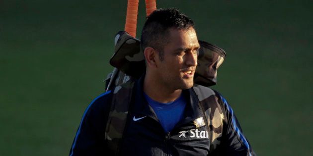Indian cricket captain Mahendra Singh Dhoni leaves after a practice session on the eve of their first Twenty20 cricket match against South Africa in Dharmsala, India, Thursday, Oct. 1, 2015. South Africa will play three Twenty20, five one-day internationals and four test matches during their 72 day tour of India. (AP Photo /Tsering Topgyal)
