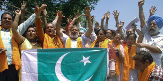 Activists of India's Shiv Sena organization burn a Pakistani flag during a demonstration in Amritsar on May 4, 2013, as they protest against the Pakistani government and the Pakistani inmates who attacked Indian prisoner Sarabjit Singh. Sarabjit Singh, an Indian convicted 16 years ago in Pakistan for spying and deadly bombings, died May 2, after being beaten in a Lahore prison, sparking a furious response from Indian politicians. AFP PHOTO/NARINDER NANU (Photo credit should read NARINDER NANU/AFP/Getty Images)