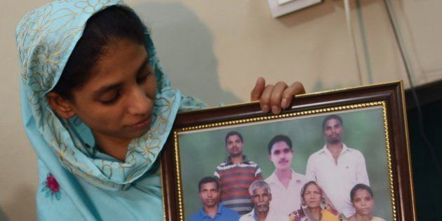 Indian woman, Geeta holds a photograph, possibly of her family, at the Edhi Foundation in Karachi on October 15, 2015. A mute and deaf Indian girl who has been stuck in Pakistan for more than a decade because she cannot remember where she came from may have finally identified her family, the charity looking after her said. The new ray of hope for the woman known only as Geeta, believed to be in her early 20s, came after the Indian High Commission in Islamabad sent her a photograph of a family, whom she said she recognised. AFP PHOTO/ RIZWAN TABASSUM (Photo credit should read RIZWAN TABASSUM/AFP/Getty Images)