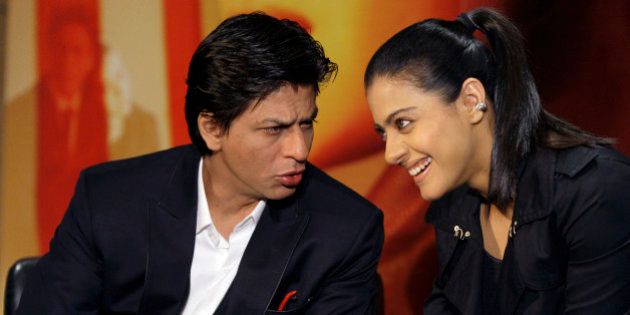 Indian actors Shah Rukh Khan, left, and Kajol Devgan talk to one another during a press conference as a trailer for their film 'My Name is Khan' is shown to an audience at a central London hotel, Wednesday, Feb. 3, 2010. (AP Photo/Joel Ryan)
