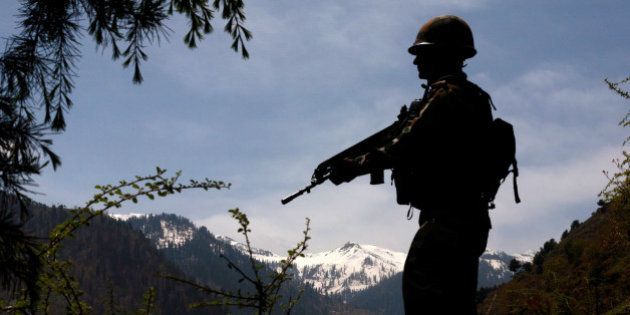 GOHALAN, KASHMIR, INDIA - APRIL 20: An Indian army soldier is silhouetted against the snow capped mountains of Pakistan administered Kashmir as he guards the the Line Of Control on April 20, 2015 in Gohalan, 120 Kms (75 miles) north west of Srinagar , the summer capital of Indian administered Kashmir, India. People living along the ceasefire line dividing Kashmir into India and Pakistan-administered portions have continually been at risk due to hostility between the armies of the two nuclear rivals. India on Sunday alledged a ceasefire violation by Pakistan along what New Delhi prefers to call the International Border and Working Boundary by Islamabad, snaking the southern Jammu region of the disputed area. The Indian army in northern Uri district say it has increased its vigil along the Line of Control (LOC), another military line that further divides the region up to the Siachen glaciers. Both Pakistan and India have traded blame over unprovoked shelling which India says is aimed to facilitate the crossover of rebels to their side, a charge Pakistan denies. (Photo by Yawar Nazir/Getty Images)