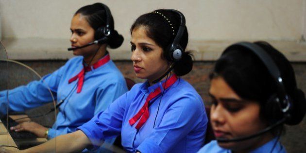 TO GO WITH INDIA-POLITICS-CRIME-UTTAR PRADESH, FOCUS, BY ANNIE BANERJIIn this photograph taken on June 15, 2014, Indian helpline operators work at the women's 'Power Helpline 1090' call centre in Lucknow. Uttar Pradesh is gaining a new reputation as India's 'failed state', with a series of rapes and killings fuelling calls for it to be brought under central government control. After yet more grim headlines over another gang-rape and fatal shooting of two policemen, Home Minister Rajnath Singh announced he was 'closely monitoring' the 'prevailing law and order situation'. With senior members of his administration warning things could get worse unless deep-rooted social problems are tackled, the heat is on Uttar Pradesh Chief Minister Akhilesh Yadav. AFP PHOTO/SANJAY KANOJIA (Photo credit should read Sanjay Kanojia/AFP/Getty Images)