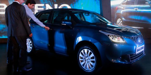 People look at the newly-unveiled Baleno hatchback during its global launch in Mumbai, India, Monday, Oct. 26, 2015. Indiaâs largest carmaker Maruti Suzuki India (MSI) Monday rolled out its latest model âBalenoâ which will be manufactured only in India and will be the first car from the MSI stable that will be exported to Japan, according to local reports. (AP Photo/Rafiq Maqbool)