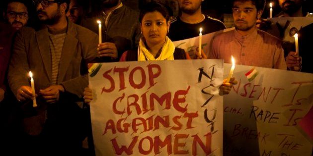 Indian youth hold candles during a protest against sexual violence in New Delhi, India, Monday, Feb. 9, 2015.Police were searching Monday for a man who raped a Japanese student sightseeing in northern India, while elsewhere they announced the arrest of eight men suspected of brutally raping and killing a Nepalese woman, as India authorities continue to struggle to address chronic sexual violence. (AP Photo/ Tsering Topgyal)