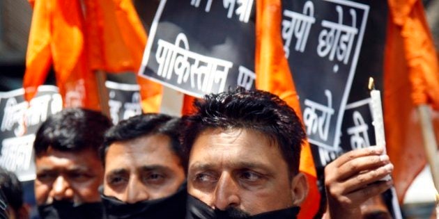 Hindu nationalist Shiv Sena party activists participate in a protest against Pakistan after Sarabjit Singh, a convicted Indian spy who was on Pakistan's death row, died from a head injury after two inmates attacked him with a brick in a Lahore jail, in Jammu, India, Thursday, May 2, 2013. Indian Prime Minister Manmohan Singh said his government would arrange to bring Singh's remains home and for his last rites to be conducted in consultation with his family. Singh was arrested in 1990 after bombings in Lahore and Faisalabad that killed 14 people and was convicted of spying and carrying out the bomb blasts, and the death sentence he received was upheld in Pakistani superior courts. (AP Photo/Channi Anand)