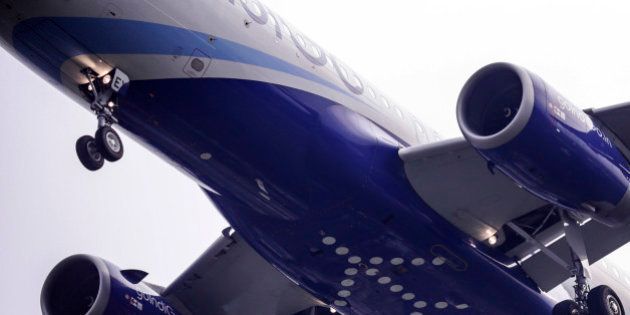 A logo sits on the underside of the fuselage of an Airbus SAS A320 aircraft operated by IndiGo, owned by Interglobe Enterprises Ltd., as it approaches the runway to land at Chhatrapati Shivaji International Airport in Mumbai, India, on Monday, Oct. 26, 2015. IndiGo, India's biggest airline by market share, is scheduled to release an initial public offering (IPO) on Oct. 27. Photographer: Dhiraj Singh/Bloomberg via Getty Images