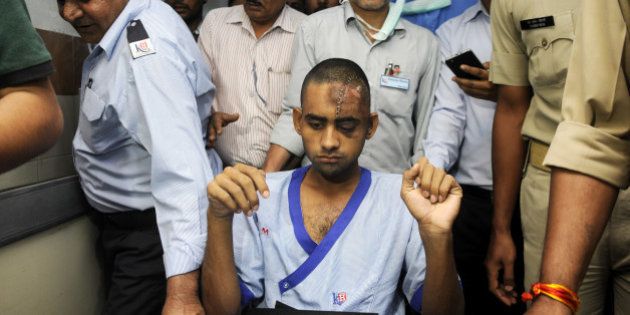NOIDA, INDIA - OCTOBER 10: Dadri lynching victim Akhlaq's son Danish (22), being shifted to Army Research and Referral (R&R) Hospital in Dhaula Kuan, Delhi, from Kailash Hospital, Noida, on October 10, 2015 in Noida, India. Danish was attacked and Akhlaq was killed by the mob after rumours that the family had consumed and stored beef in their house at Bishara village in Dadri, Uttar Pradesh. (Photo by Sunil Ghosh/Hindustan Times via Getty Images)