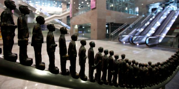 Sculptures in the likeness of passengers stand on display at the Delhi Metro Airport Express Line station in New Delhi, India, Saturday, Feb. 5, 2011. The metro line linking New Delhi Metro Station to the Indira Gandhi International Airport began services Saturday and plan to offer passengers the facility to check-in at metro stations. (AP Photo/Mustafa Quraishi)