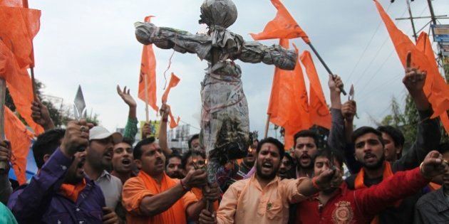 India's Hindu right-wing Shiv Sena activists prepare to burn an effigy of Kashmiri separatist Masarat Alam during a protest in Jammu, India, Thursday, April 16, 2015. The right-wing activists were protesting after Kashmiri supporters raised pro-Pakistan slogans and waved Pakistani flags at a rally organized by separatists in Indian controlled Kashmir Wednesday. (AP Photo/Channi Anand)