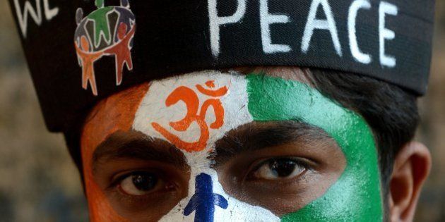 An Indian student with a peace message painted on his face attends a peace rally on the 65th death anniversary of 'father of the nation' Mahtama Gandhi, in Mumbai on January 30, 2013. Students and people from various walks of life took part in the rally for peace and communal harmony. AFP PHOTO/Indranil MUKHERJEE (Photo credit should read INDRANIL MUKHERJEE/AFP/Getty Images)