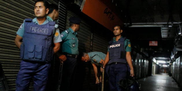 Bangladeshi security officers stand guard at the site where the slaughtered body of Faisal Arefin Deepan was found in Dhaka, Bangladesh, Saturday, Oct. 31, 2015. The publisher of secular books was hacked to death and three other people were wounded in two separate attacks Saturday at publishing houses in Bangladesh's capital, police said. Both of the publishers involved in Saturday's attacks had published works of Bangladeshi-American blogger and writer Avijit Roy, who was hacked to death on the Dhaka University campus while walking with his wife in February. (AP Photo/A.M. Ahad)