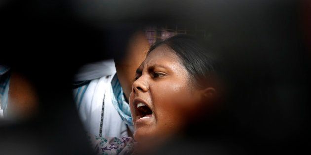 A member of Jawaharlal Nehru University Students Union shouts slogans during a protest against a gang rape of two teenage girls in Katra village, outside the Uttar Pradesh state house, in New Delhi, India, Friday, May 30, 2014. A top government official said the northern Uttar Pradesh state has sacked two police officers who failed to respond to a complaint by the father of the two teenage girls who went missing and were later found gang raped and killed. (AP Photo/Manish Swarup)