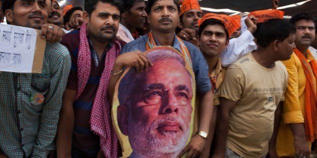 Supporters of Indiaâs main opposition and Hindu nationalist Bharatiya Janata Party (BJP) prime ministerial candidate Narendra Modi attend a political rally in Robertsganj, in the northern Indian state of Uttar Pradesh, Saturday, May 10, 2014. During his campaign, Modi has not played up his party's Hindu agenda, but experts say his decision to run from the nearby holy city of Varanasi is meant to send a clear message to all voters about his commitment to the BJP's brand of religious nationalism, which emphasizes India's Hindu identity. (AP Photo/Bernat Armangue)