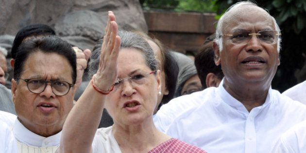 NEW DELHI, INDIA - AUGUST 5: Congress President Sonia Gandhi (C) joins other Congress Party members to shout slogans against Prime Minister Narendra Modi and the NDA government at Parliament House on August 5, 2015 in New Delhi, India. Congress and some opposition parties on Wednesday persisted with their protest against the suspension of 25 MPs as the stalemate in the Rajya Sabha continued over the opposition demand for the resignations of three BJP leaders. (Photo by Sonu Mehta/Hindustan Times via Getty Images)