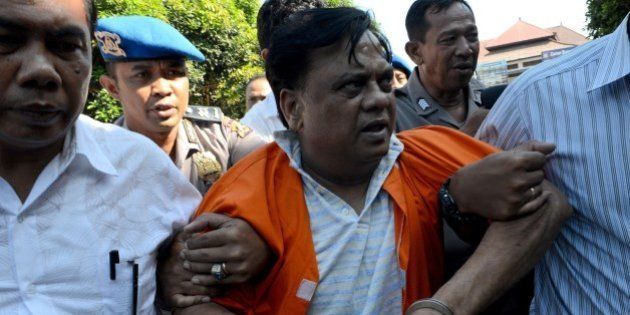 Indian national Rajendra Sadashiv Nikalje, 55, known in India as Chhota Rajan, is brought out from a holding cell at the Bali police headquarters in Denpasar on Bali island on November 2, 2015. An alleged Indian crime boss wanted in his home country for up to 20 murders has been arrested in Indonesia after two decades on the run, police said October 26. Nikalje had been evading police in several countries for years, with Interpol flagging him as a wanted man back in 1995. AFP PHOTO / SONNY TUMBELAKA (Photo credit should read SONNY TUMBELAKA/AFP/Getty Images)