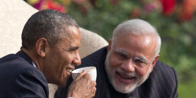 President Barack Obama and Indian Prime Minister Narendra Modi have coffee and tea in the gardens of the Hyderabad House in, New Delhi, India, Sunday, Jan. 25, 2015. (AP Photo/Carolyn Kaster)