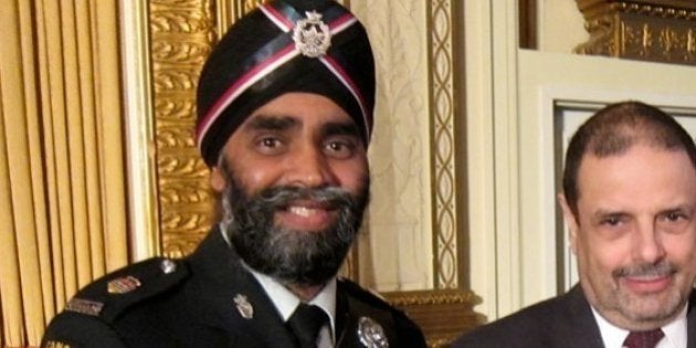 Lt. Col. Harjit Sajjan and Hon. Lt. Col. Robert Stanley present Consul General Phil Chicola with a certificate of appreciation.