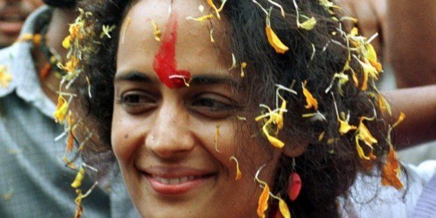 Booker prize winner Arundhati Roy gets showered by flower petals as she visits Parthrad village in central India, Saturday July 31, 1999. The writer is lending her support against the Narmada Dam project which is likely to displace over 60 villages including Parthrad. The dam on the 1300kms long Narmada river has been opposed for the last 14 years. (AP Photo/Sherwin Crasto)