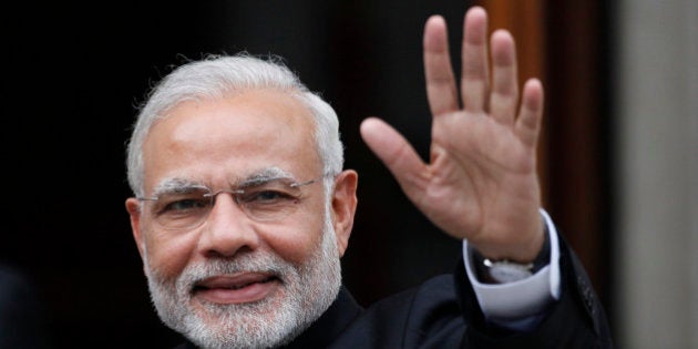 Indian Prime Minister Narendra Modi waves as he arrives for a meeting with Irish Prime Minister Enda Kenny at Government Buildings, Dublin, Ireland, Wednesday, Sept. 23, 2015. Modi arrived in Ireland for high level talks focusing on strengthening economic, trade and investment between the two countries. (AP Photo/Peter Morrison)