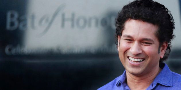 FILE - In this March 2, 2014 file photo, India's cricket icon Sachin Tendulkar stands near a large steel bat which has been unveiled as a monument in his honor, in Mumbai, India. Cricket great Tendulkar considered early retirement after a string of losses while India's captain according to excerpts from the record-holding batsman's autobiography, published on Sunday, Nov. 2, 2014. (AP Photo/Rafiq Maqbool, File)