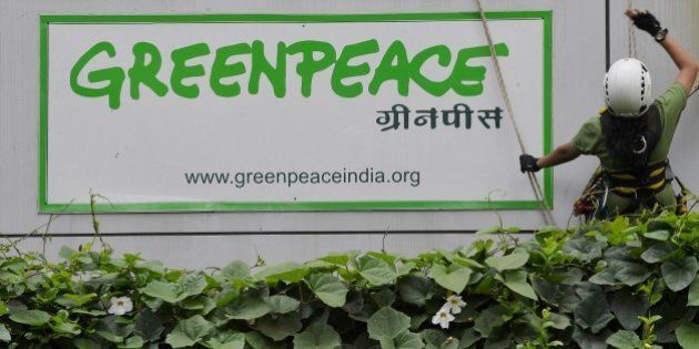 Activists of GreenPeace rappell down their office building where they are head quartered to unfurl banners 'democracy' and 'freespeech' in Bangalore on May 15, 2015. Greenpeace India, which is on the verge of closing down after the Indian government blocked its domestic accounts, is planning to appeal to the judiciary for relief. The NGO recently told its employees that the threat of an imminent shutdown is looming large as it has been left with cash reserves for salaries and office costs for just about a month. AFP PHOTO/ Manjunath KIRAN (Photo credit should read Manjunath Kiran/AFP/Getty Images)