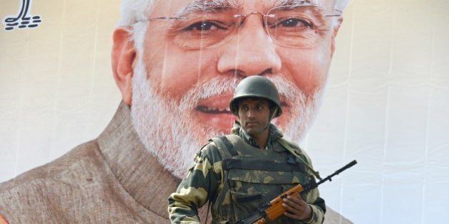 An Indian Border Security Force (BSF) soldier stands guard alongside a poster bearing the image of Indian Prime Minister Narendra Modi near the venue of Modi's scheduled rally in Srinagar on November 6, 2015. The hardline faction of the Hurriyat Conference, supported by moderate separatists, has announced a 'Million March' on November 7, the day Prime Minister Narindra Modi is scheduled to address a rally in Srinagar. The state government has launched a massive crackdown on separatist leaders ahead of Prime Minister Modi's visit to the state, with all prominent separatist leaders either detained or put under house arrest, forces deployed in large numbers and barricades erected at sensitive areas. AFP PHOTO/ Tauseef MUSTAFA (Photo credit should read TAUSEEF MUSTAFA/AFP/Getty Images)