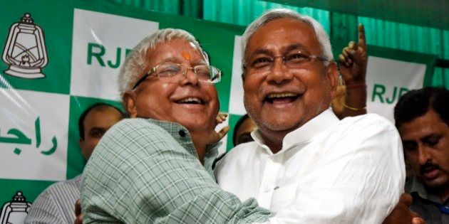 PATNA, INDIA - NOVEMBER 8: RJD Chief Lalu Prasad Yadav and Nitish Kumar celebrate after Mahagathbandhan's (Grand Alliance) victory in Bihar assembly elections at RJD office, on November 8, 2015 in Patna, India. Nitish Kumar said, 'I express my gratitude towards people of Bihar, will try our best to match up with their expectations. We respect our opposition in Bihar; want to work in consensus with everyone to develop Bihar. This victory is big win and we will work towards the Grand Alliances mandate for the development of Bihar.' Lalu Yadav said, 'BJP had its eyes on Kolkata, the capital of West Bengal. It wanted to move eastwards. Bihar stopped them in tracks. PM Narendra Modi is nothing but an RSS pracharak.' The grand alliances victory is also attributed to the rejection of communal politics, driven mostly by the recent debate over cow slaughter and consumption of beef. Data from the election commissions website for 240 of the states 243 seats showed the RJD-JD(U)-Congress alliance led in 178 seats, an emphatic victory over the NDA that could only win around 59 seats. (Photo by Arun Sharma/Hindustan Times via Getty Images)