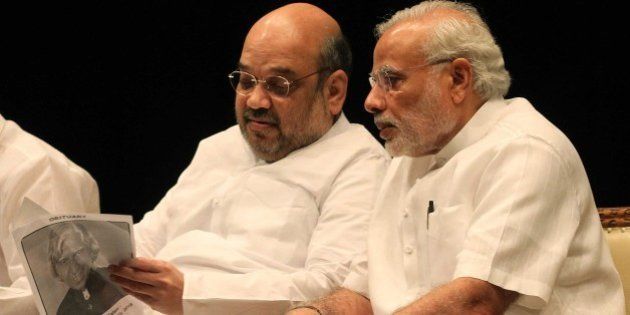 NEW DELHI, INDIA - JULY 28: Prime Minister Narendra Modi with BJP President Amit Shah at BJP Parliamentary party leaders meeting at the Parliament House Library during the ongoing Monsoon Session, on July 28, 2015 in New Delhi, India. As a mark of respect to the departed former President A.P.J. Abdul Kalam, members of both Houses stood in silence before the proceedings were adjourned for the day. Both Houses were adjourned till July 30. (Photo by Sonu Mehta/Hindustan Times via Getty Images)