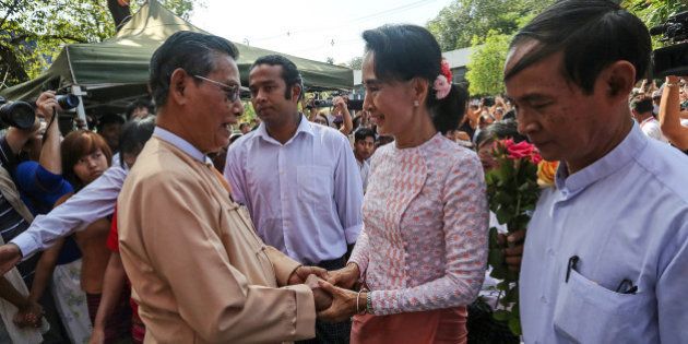 Aung San Suu Kyi, Myanmar's opposition leader and chairperson of the National League for Democracy (NLD), center right, greets Tin Oo, co-founder of the NLD, as she arrives at the party headquarters in Yangon, Myanmar, on Monday, Nov. 9, 2015. Suu Kyi warned supporters anticipating an historic election victory over the military-backed ruling party that results are not final and they need to remain cautious. Photographer: Dario Pignatelli/Bloomberg via Getty Images