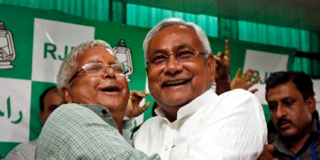 PATNA, INDIA - NOVEMBER 8: RJD Chief Lalu Prasad Yadav and Nitish Kumar celebrate after Mahagathbandhan's (Grand Alliance) victory in Bihar assembly elections at RJD office, on November 8, 2015 in Patna, India. Nitish Kumar said, 'I express my gratitude towards people of Bihar, will try our best to match up with their expectations. We respect our opposition in Bihar; want to work in consensus with everyone to develop Bihar. This victory is big win and we will work towards the grand alliances mandate for the development of Bihar.' Lalu Yadav said, 'BJP had its eyes on Kolkata, the capital of West Bengal. It wanted to move eastwards. Bihar stopped them in tracks. PM Narendra Modi is nothing but an RSS pracharak.' The grand alliances victory is also attributed to the rejection of communal politics, driven mostly by the recent debate over cow slaughter and consumption of beef. Data from the election commissionâs website for 240 of the stateâs 243 seats showed the RJD-JD(U)-Congress alliance led in 178 seats, an emphatic victory over the NDA that could only win around 59 seats. (Photo by Arun Sharma/Hindustan Times via Getty Images)