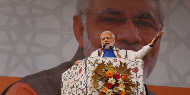Indian Prime Minister Narendra Modi speaks during a public rally in Srinagar, Indian controlled Kashmir, Saturday, Nov. 7, 2015. Modi on Saturday promised a $12 billion federal aid package to boost economic growth in the Indian-controlled portion of the troubled Kashmir region. (AP Photo/Mukhtar Khan)