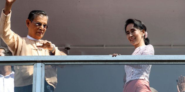 Aung San Suu Kyi, Myanmar's opposition leader and chairperson of the National League for Democracy (NLD), right, and U Thin Oo, vice-chairman of the NLD, stand on a balcony at the party headquarters in Yangon, Myanmar, on Monday, Nov. 9, 2015. Suu Kyi warned supporters anticipating an historic election victory over the military-backed ruling party that results are not final and they need to remain cautious. Photographer: Dario Pignatelli/Bloomberg via Getty Images