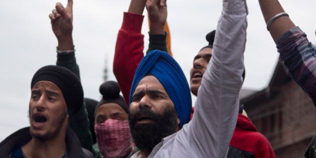 Sikhs shout slogans against Indian security forces during a protest in Srinagar, Friday, June 5, 2015. On Thursday, local authorities in Jammu removed posters of Sikh leader Jarnail Singh Bhindranwal triggering clashes between members of the Kashmiri Sikh and Indian security forces. (AP Photo/Dar Yasin)