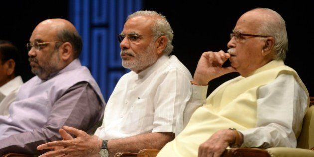 Indian Prime Minister Narendra Modi (C), Bharatiya Janata Party (BJP) President Amit Shah (L) and Senior BJP Leader L. K. Advani (R) attend the BJP parliamentary committee meeting at the parliament building in New Delhi on July 22, 2015. The three-week long monsoon session of the Indian parliament began on July 22, with the ruling Bharatiya Janata Party's (BJP) intent on discussing three bills land acquisition, goods and services (GST) tax, and revision of labour laws. AFP PHOTO / PRAKASH SINGH (Photo credit should read PRAKASH SINGH/AFP/Getty Images)