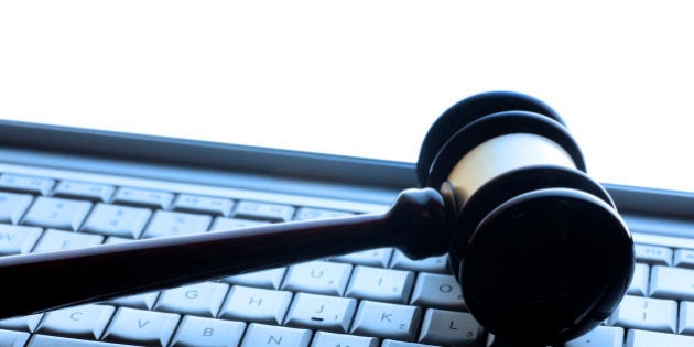 A gavel on a computer keyboard representing an internet auction or computer related crime.