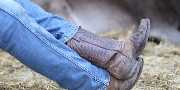 Lazy Cowboy leather boots and pants in blue jeans in the stable of bulls