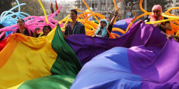 Supporter of the lesbian, gay, bisexual and transgender community wave a rainbow flag during a gay pride parade in Mumbai, India, Saturday, Jan. 31, 2015. Gay rights supporters waved flags and danced during the march to celebrate gay pride and to push for the repeal of a colonial-era law that makes homosexuality a crime. (AP Photo/Rajanish Kakade)