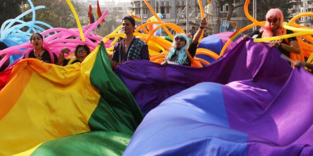 Supporter of the lesbian, gay, bisexual and transgender community wave a rainbow flag during a gay pride parade in Mumbai, India, Saturday, Jan. 31, 2015. Gay rights supporters waved flags and danced during the march to celebrate gay pride and to push for the repeal of a colonial-era law that makes homosexuality a crime. (AP Photo/Rajanish Kakade)