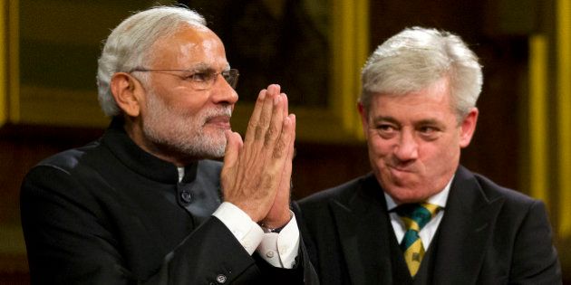 LONDON, UNITED KINGDOM - NOVEMBER 12: Indian Prime Minister Narendra Modi acknowledges applause next to Speaker of the House of Commons John Bercow after addressing members of parliament and invited guests in the Royal Gallery at the Houses of Parliament during an official three day visit on November 12, 2015 in London, England. In his first trip to Britain as Prime Minister Modi's visit will aim to develop economic ties between the two countries. In a busy schedule he is due to speak at Wembley Stadium, lunch with the Queen at Buckingham Palace, address Parliament and stay overnight at Chequers. (Photo by Justin Tallis - WPA Pool/Getty Images)