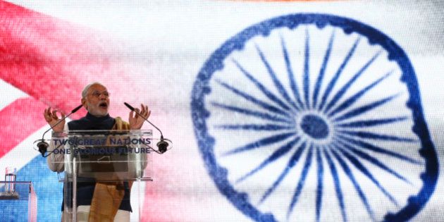 LONDON, UNITED KINGDOM - NOVEMBER 13: India's Prime Minister Narendra Modi speaks on stage at Wembley Stadium during a welcome rally on November 13, 2015, in London, England. In his first trip to Britain as Prime Minister Modi's visit will aim to develop economic ties between the two countries. In a busy schedule he is due to speak at Wembley Stadium, have lunch with the Queen at Buckingham Palace, address Parliament and stay overnight at Chequers. (Photo by Justin Tallis - WPA Pool/Getty Images)