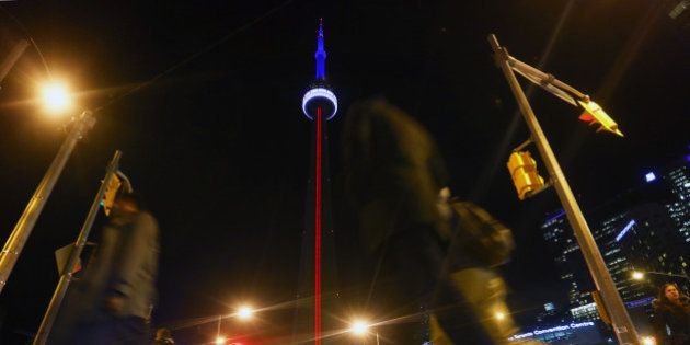 TORONTO, ON - NOVEMBER 13 - The CN Tower lit up with the colours of the French Flag in support of France in the face of tragedy, on November 13, 2015 (Cole Burston/Toronto Star via Getty Images)